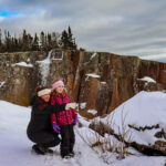 A mom and her young daughter enjoy a snowy outing in Minnesota.