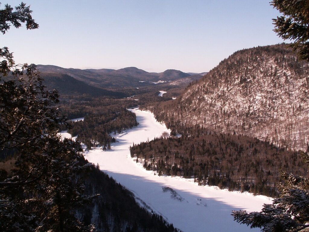 A view of Jacques-Cartier National Park in the snow, one of the best winter vacations for families.