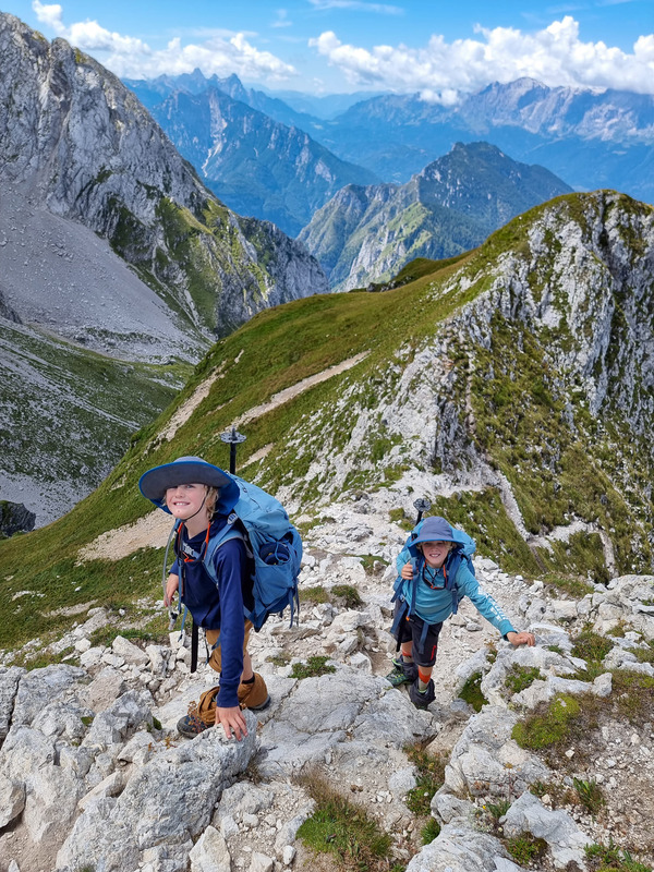 Two kids hike amongst the Dolomites of Italy.